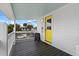 Front porch entry with yellow door and welcome sign at 1306 Palmetto Blvd, Edisto Beach, SC 29438