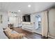 Living room with sofa, TV, and access to deck at 1306 Palmetto Blvd, Edisto Beach, SC 29438