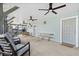 Covered patio with seating and ceiling fans at 1306 Palmetto Blvd, Edisto Beach, SC 29438