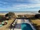Ocean view of private pool with lounge chairs at 1306 Palmetto Blvd, Edisto Beach, SC 29438