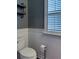 Clean bathroom with toilet, wall mounted shelving, and wainscoting at 1504 Oldenburg Dr, Mount Pleasant, SC 29466