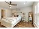Spacious bedroom with a farmhouse bed, hardwood floors, and access to a bathroom at 1504 Oldenburg Dr, Mount Pleasant, SC 29466