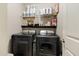 Convenient laundry room with washer, dryer, and shelving for storage at 1504 Oldenburg Dr, Mount Pleasant, SC 29466