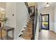 Elegant staircase with wrought iron railing and neutral runner at 1504 Oldenburg Dr, Mount Pleasant, SC 29466