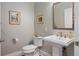 Powder room with pedestal sink and stylish patterned wallpaper at 155 Wingo Way # 418, Mount Pleasant, SC 29464