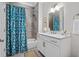 Bright bathroom with white vanity, marble countertop, and teal shower curtain at 155 Wingo Way # 418, Mount Pleasant, SC 29464