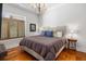 Bedroom with beige bed and wooden floors at 155 Wingo Way # 418, Mount Pleasant, SC 29464