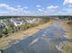 Aerial view showcasing waterfront property with marsh and community at 1857 Palmetto Isle Dr, Mount Pleasant, SC 29466