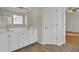 Bathroom with double vanity, white cabinets, and tiled floors at 1857 Palmetto Isle Dr, Mount Pleasant, SC 29466