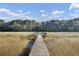 Wooden dock extends over calm water, offering serene views at 1857 Palmetto Isle Dr, Mount Pleasant, SC 29466