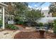 Landscaped backyard with brick pathway and seating area at 209 Bennett St, Mount Pleasant, SC 29464
