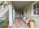 Covered porch with brick flooring and wooden bench at 209 Bennett St, Mount Pleasant, SC 29464