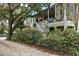 Two-story home with white staircase and lush landscaping at 209 Bennett St, Mount Pleasant, SC 29464
