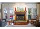 Brick fireplace with wooden mantel is the focal point of this room at 209 Bennett St, Mount Pleasant, SC 29464