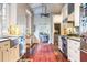 Long kitchen with island and stainless steel appliances at 209 Bennett St, Mount Pleasant, SC 29464