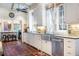 Kitchen with farmhouse sink, stainless steel appliances, and white cabinets at 209 Bennett St, Mount Pleasant, SC 29464