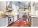 View of kitchen with stainless steel appliances and brick backsplash at 209 Bennett St, Mount Pleasant, SC 29464