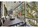 Relaxing porch with shaded seating area and view of lush trees at 209 Bennett St, Mount Pleasant, SC 29464