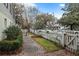 Landscaped side yard with brick and gravel pathway at 209 Bennett St, Mount Pleasant, SC 29464