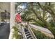 Charming staircase leading to a porch overlooking a tree-lined street at 209 Bennett St, Mount Pleasant, SC 29464