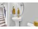 Stylish powder room with pedestal sink and gold fixtures at 234 Oak Park St, Summerville, SC 29486