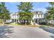 Row of white houses with red doors and lush green trees at 234 Oak Park St, Summerville, SC 29486