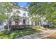 White two-story home with red doors, landscaping, and a sidewalk at 234 Oak Park St, Summerville, SC 29486