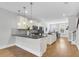 Open concept kitchen with island, stainless steel appliances, and hardwood floors at 234 Oak Park St, Summerville, SC 29486