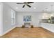 Spacious living room with hardwood floors, ceiling fan, and kitchen access at 234 Oak Park St, Summerville, SC 29486