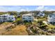 Aerial view of a neighborhood of houses, including a white two-story home at 2618 Raven Dr, Sullivans Island, SC 29482