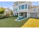 Luxury home with a freeform pool and spa, surrounded by lush landscaping at 2618 Raven Dr, Sullivans Island, SC 29482