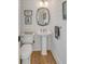 Powder room with pedestal sink and wood flooring at 2618 Raven Dr, Sullivans Island, SC 29482