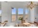 Bright dining room with large windows and a charming chandelier at 2618 Raven Dr, Sullivans Island, SC 29482