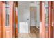 Bright entryway with hardwood floors, white walls, and a wooden door at 2618 Raven Dr, Sullivans Island, SC 29482