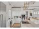 White kitchen with marble countertops and stainless steel appliances at 2618 Raven Dr, Sullivans Island, SC 29482