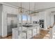 Gourmet kitchen with island, stainless steel appliances, and white cabinetry at 2618 Raven Dr, Sullivans Island, SC 29482