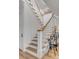 Elegant staircase with white walls and wooden accents at 2618 Raven Dr, Sullivans Island, SC 29482