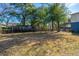 Large backyard with mature trees and wooden fence at 2749 E Surrey Dr, North Charleston, SC 29405