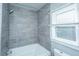 Modern bathroom with gray tile and a shower/tub combo at 2749 E Surrey Dr, North Charleston, SC 29405