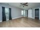 Main bedroom with light wood floors and a barn door to the bathroom at 2749 E Surrey Dr, North Charleston, SC 29405