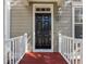 Black front door with sidelights and red painted porch at 2971 Treadwell St St, Mount Pleasant, SC 29466