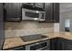 Modern kitchen with granite countertops and dark cabinetry at 2971 Treadwell St St, Mount Pleasant, SC 29466