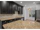 Island kitchen with granite countertops and dark cabinetry at 2971 Treadwell St St, Mount Pleasant, SC 29466