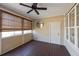 Bright screened porch with wood flooring, ceiling fan and neutral tones at 2971 Treadwell St St, Mount Pleasant, SC 29466