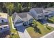 Aerial view of a charming light green house with a gray roof and a two-car garage, situated in a well-maintained neighborhood at 311 Calm Water Way, Summerville, SC 29486