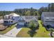 Aerial view of a charming light green house with a gray roof and a two-car garage, situated in a well-maintained neighborhood at 311 Calm Water Way, Summerville, SC 29486
