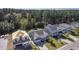 Aerial view of a charming light green house with a gray roof and a two-car garage, situated in a well-maintained neighborhood at 311 Calm Water Way, Summerville, SC 29486