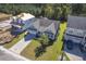 Aerial view of a charming light green house with a gray roof and a two-car garage, situated in a well-maintained neighborhood at 311 Calm Water Way, Summerville, SC 29486