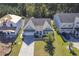 Aerial view of a charming light green house with a gray roof and a two-car garage, situated in a well-maintained neighborhood at 311 Calm Water Way, Summerville, SC 29486