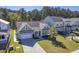 Aerial view of a charming light green house with a gray roof and a two-car garage, situated in a well-maintained neighborhood at 311 Calm Water Way, Summerville, SC 29486